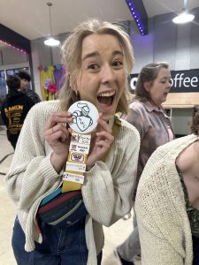 2020 Grad, Ellie Hilderbrand shows off her Crusader Button and theater production line up.